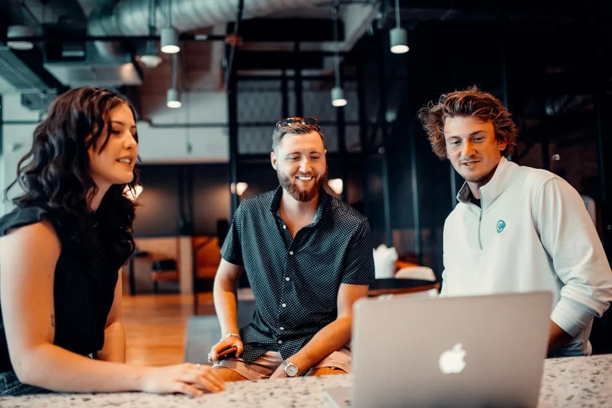 Team reviewing CRM data together on a laptop in an office