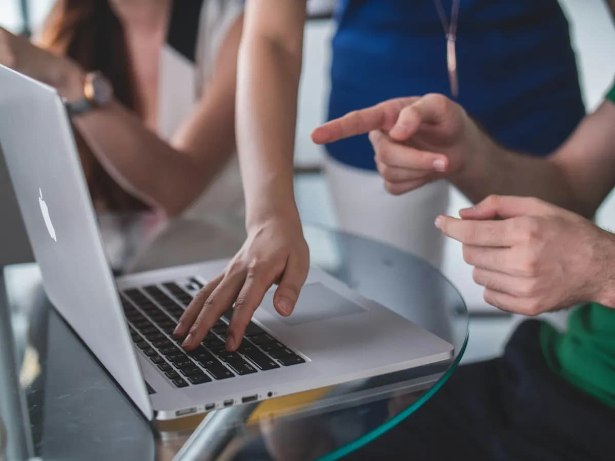 Two people reviewing a website and CRM integration on a laptop