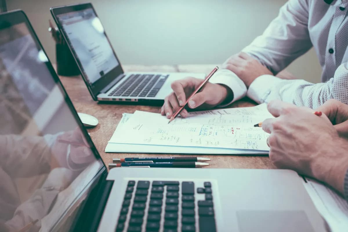 Business owner sketching a website plan next to a laptop