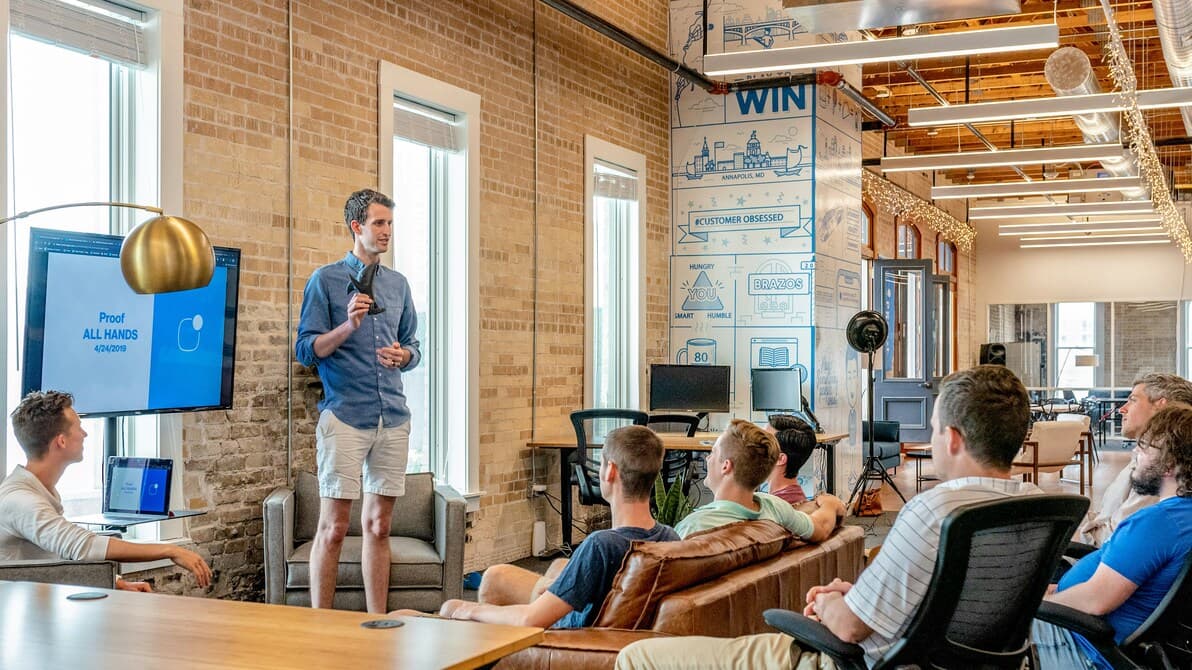 Team presenting a project plan in an open studio